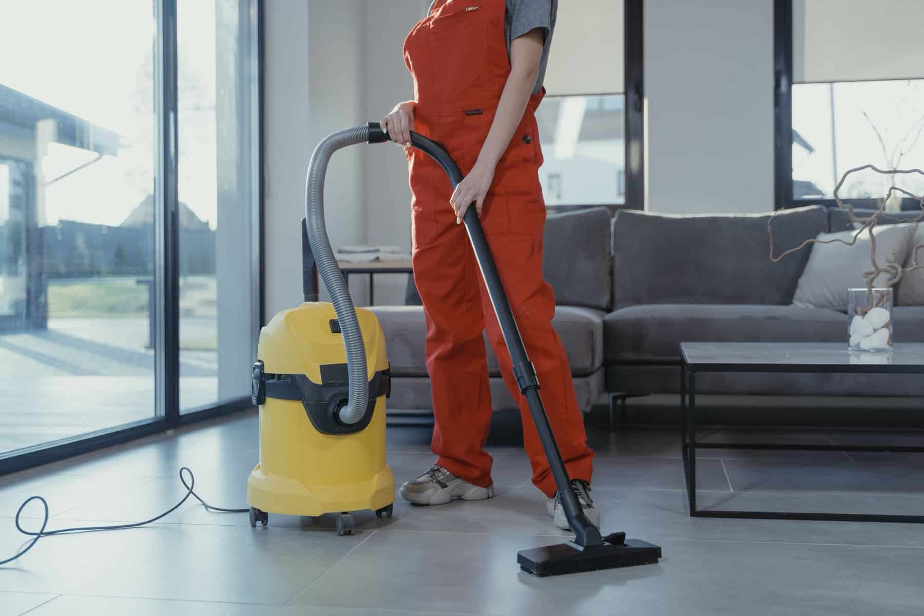 A professional cleaner at work, illustrating what a cleaning business website costs