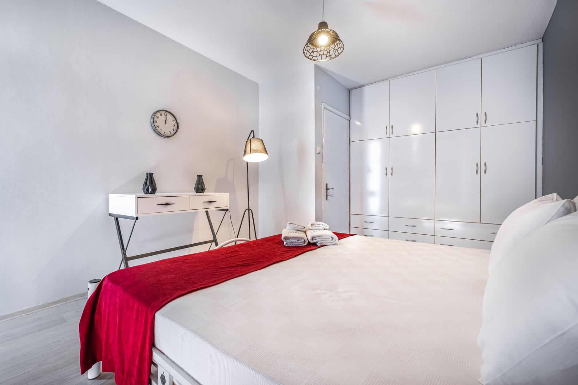 Professional cleaner preparing a tidy holiday let bedroom for Airbnb cleaning clients
