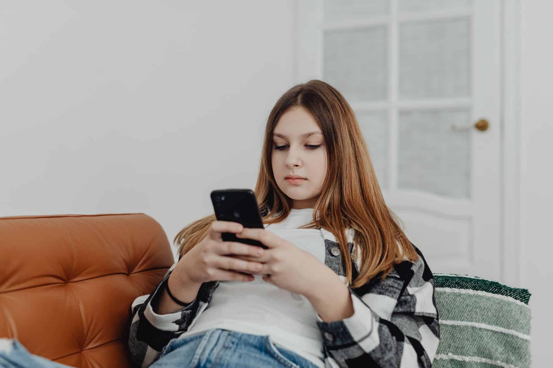 Customer looking at a cleaning company website on a phone while deciding how to choose a cleaner