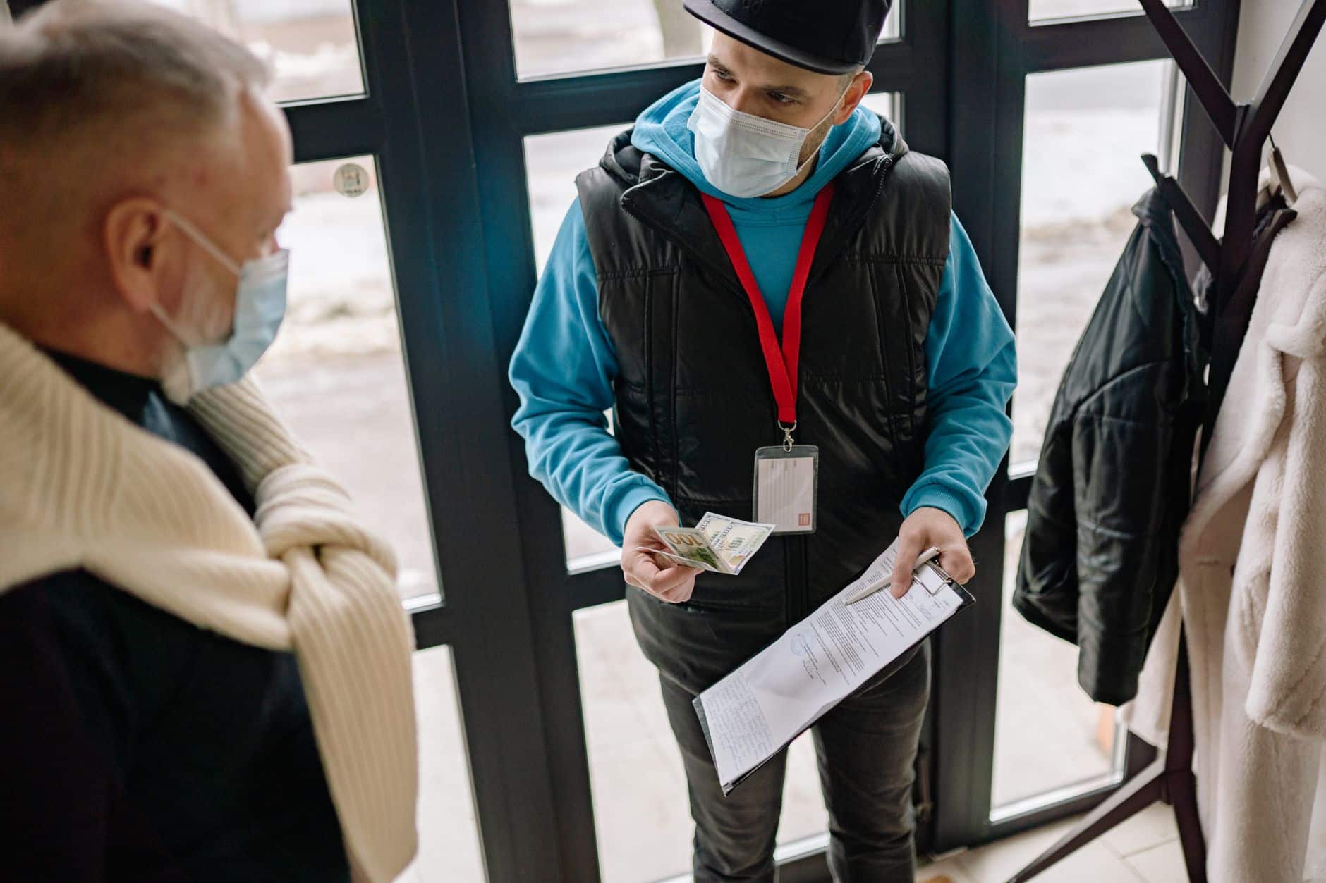 Cleaner checking a clipboard at a customer doorstep and looking out for client red flags