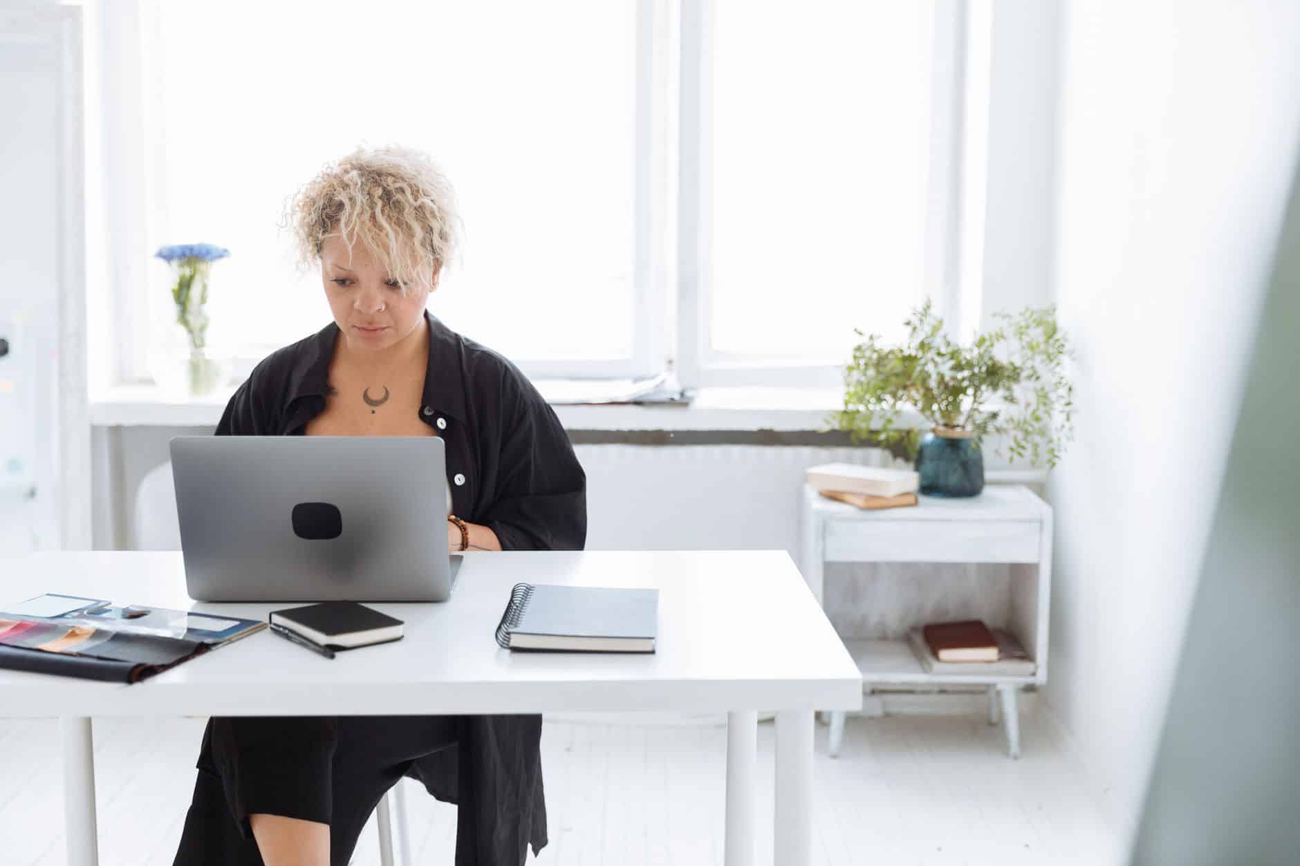 Cleaning business owner comparing a DIY website builder with a managed website on a laptop